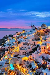 Foto auf Acrylglas Famous greek iconic selfie spot tourist destination Oia village with traditional white houses and windmills in Santorini island in the evening blue hour, Greece © Dmitry Rukhlenko