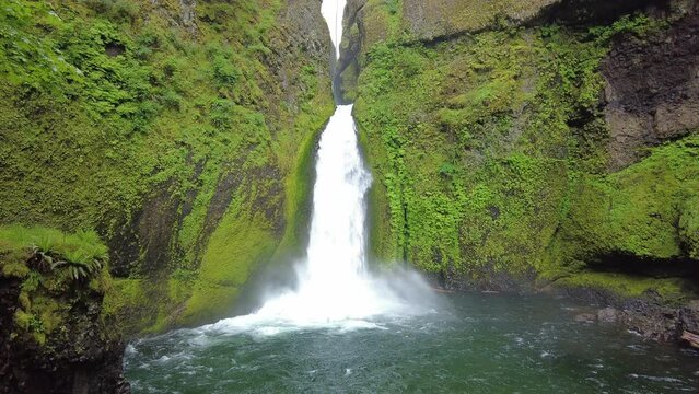 Wahclella Falls flows down a basalt cliff into a beautiful slot canyon and eventually runs into the scenic Columbia River Gorge in Oregon.