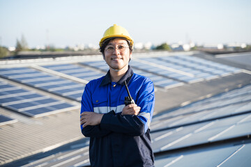 Portrait of Asian engineer on background field of photovoltaic solar panels solar cells on roof top...
