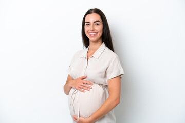 Young caucasian woman isolated on white background pregnant and happy