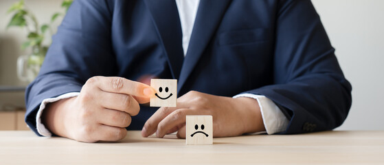 Businessman as customer rating service experience in wooden blocks facial emotions. Client feedback...