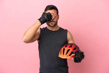 Young cyclist man isolated on pink background covering eyes by hands. Do not want to see something - obrazy, fototapety, plakaty