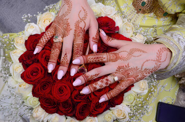 Henna Tattoo on Bride's Hand.Moroccan wedding preparation henna party. Temperate white mehndi. Modern mehendi art...