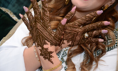 Henna Tattoo on Bride's Hand.Moroccan wedding preparation henna party. Temperate white mehndi. Modern mehendi art...
