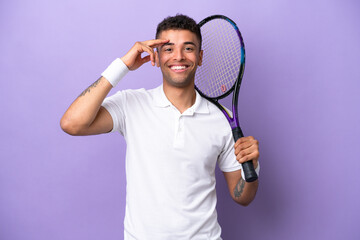 Young Brazilian man isolated on purple background playing tennis