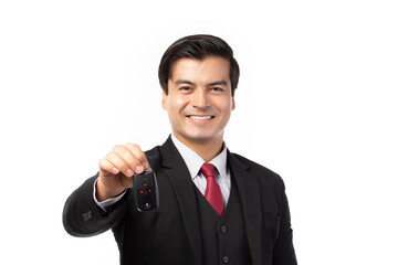 Naklejka premium Portrait of a confident business man in black suit feeling happy and smile holding the keys of the car isolated on white background.