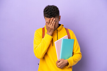 Young student Brazilian man isolated on purple background with tired and sick expression