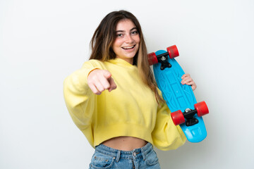 Young caucasian woman isolated on white background with a skate and pointing to the front