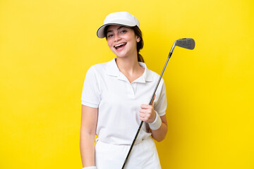 young caucasian woman playing golf isolated on yellow background laughing - Powered by Adobe