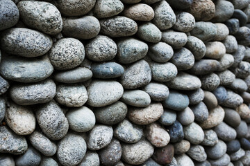 Cobblestone wall texture background . Ancient weathered wall . Natural pattern