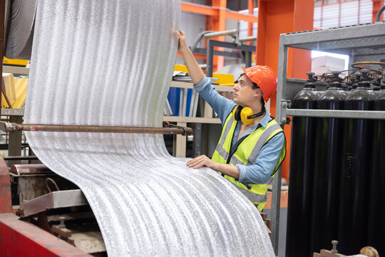 Factory Worker Working with Thermal Insulating Sheet in the Factory