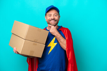 Super Hero delivery man isolated on blue background happy and smiling