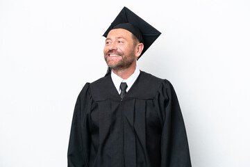 Middle age university graduate man isolated on white background posing with arms at hip and smiling