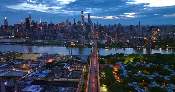 Picturesque scenery of evening New York. The 59th Street Bridge with lively traffic. Aerial view.