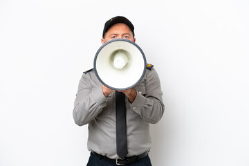 Middle age security man isolated on white background shouting through a megaphone