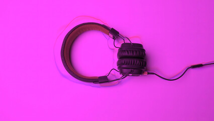 Headphones on colored background with lines. Animation. New headphones lie on colored background with animated lines. Animated lines follow shape of headphones