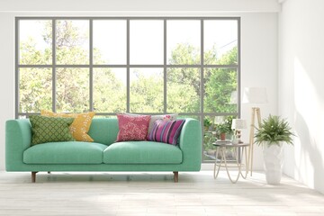 Fototapeta na wymiar White living room with colorful sofa and summer landscape in window. 3D illustration