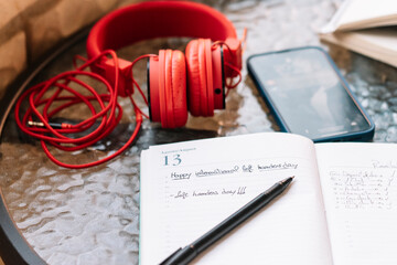 Happy lefties day! A notebook with the day August 13 with the words "Left handers day" written on it.