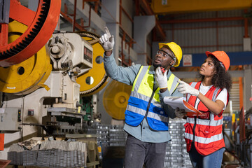 Fototapeta premium Black Engineer Check the Machine in the Metal Sheet Factory