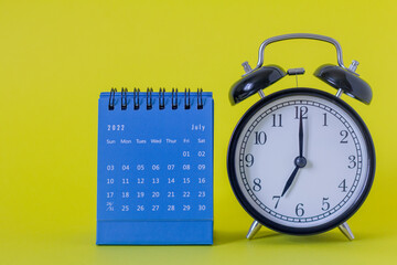 Desktop calendar for July 2022 on a yellow background.