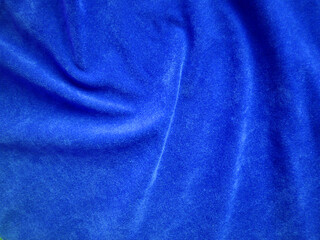 Blue velvet fabric texture used as background. Empty blue fabric background of soft and smooth...