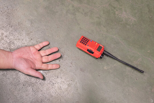 Unconscious Man Hand Falling on the Factory Floor with his Walkie Talkie