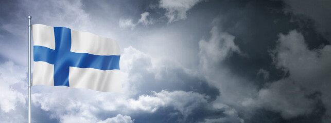 Obraz premium Finnish flag on a cloudy sky