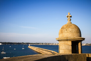 Saint-Malo lighthouse and pier view from the city fortifications, Brittany, France