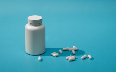 jar of pills isolated on blue background