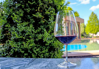 a glass of red wine outdoors on the terrace