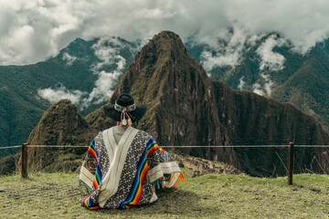 Tourist photography in Machu Picchu. Traveler with poncho and Inca hat. Wonder of the World. Colors - obrazy, fototapety, plakaty