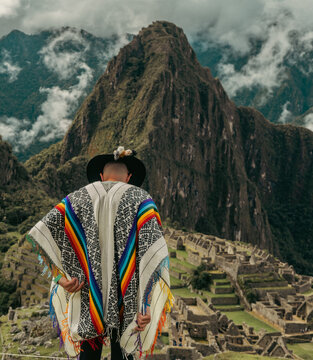 Tourist photography in Machu Picchu. Traveler with poncho and Inca hat. Wonder of the World. Colors