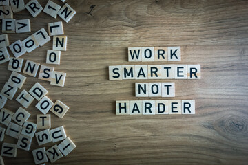 Work smarter not harder text. Motivational reminder from wooden blocks