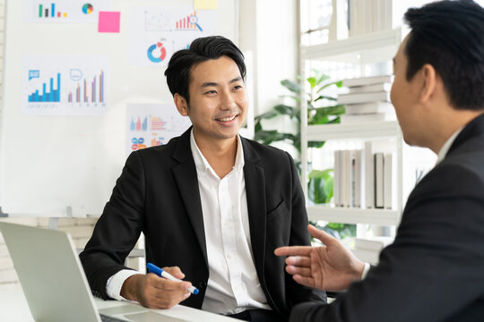 Group Of Asian Businessman Wear Suit Discussion Business Plan In The Office. Asian Businessman Talking Strategy Plan With Partner Or Colleagues. Business, People