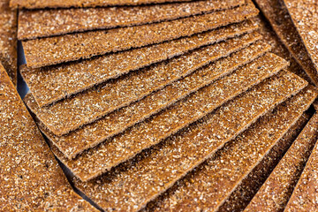 Crispy thin rye bread stack for eating as a food background.