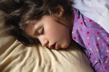 Healthy sleep of a little girl, time before waking up