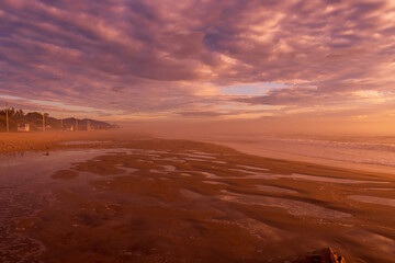 Sunrise with clouds and fog on beach in Florianopolis