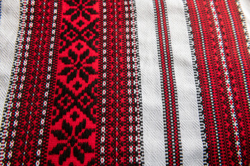 National traditional Ukrainian folk towels with embroidery and handmade patterns on a wooden pottery table in daylight