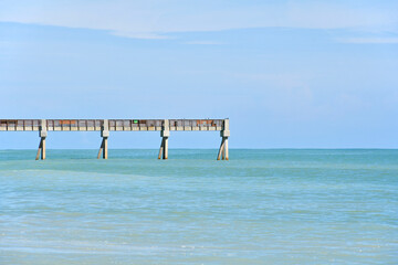 Fototapeta na wymiar Vero Beach Pier on a beautiful, calm beach day in Vero Beach, Florida