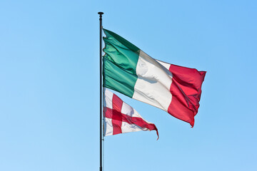 Flag of Italy and Flag of Genoa on sky background