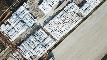 Aerial top view of building materials warehouse. Stock footage. Large storage of construction materials in industrial city zone from above.