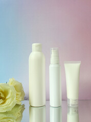Fototapeta na wymiar Mockup white plastic tube for moisturizer, lotion, facial cleanser or shampoo on smudged cream.