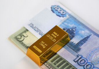 banknotes of dollars and Russian rubles, laid out in small bundles on top of a gold ingot. the concept of abandoning dollars and strengthening the economy during the sanctions pressure
