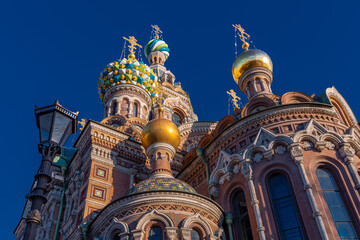 Fototapeta na wymiar Bottom-up view of colorful Russian Orthodox cathedral against clear blue sky, St.Petersburg, Russia