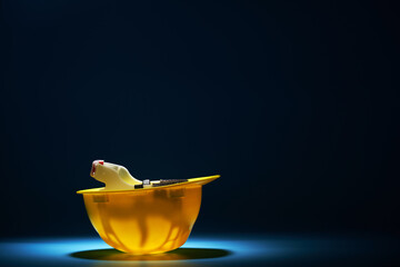 yellow helmet upside down against blue background