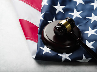 Wooden gavel of the judge on the American flag. Isolated on white background. Fair trial, rule of law, auction. There are no people in the photo. There is free space to insert.