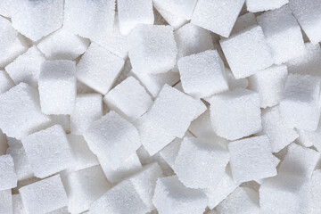 Rafinated sugar. Textured white background from sugar cubes.