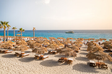 Beautiful empty beach with umbrellas and sunbeds