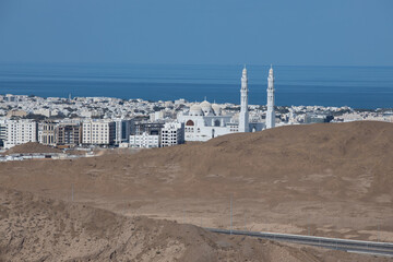 Fototapeta na wymiar Muscat Oman city landscape and buildings with sea background