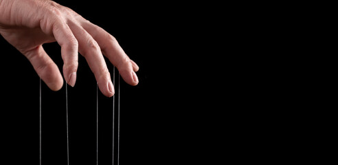 Banner with man hand with strings on fingers. Manipulation or addiction concept. Master, abuser...
